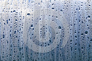 Texture of rain drops on a glass wet transparent surface