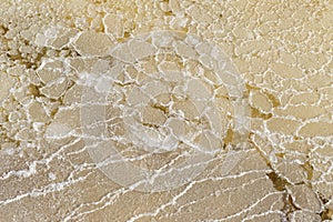 Texture of raw salt on sea water in evaporation ponds process at
