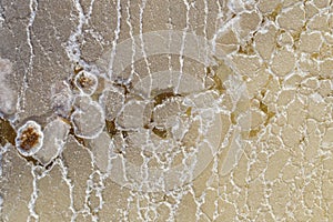 Texture of raw salt on sea water in evaporation ponds process at