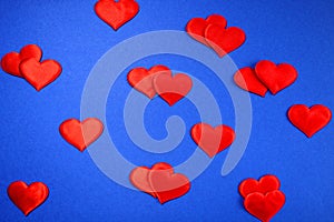 Texture of red hearts on a blue background