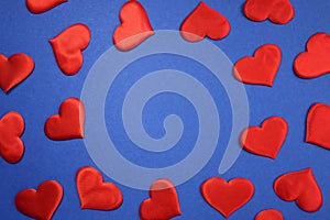 Texture of red hearts on a blue background