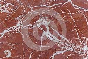 The texture of the red marble slab on the wall