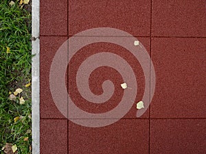 Texture of red rubber floor used for safety kids playground