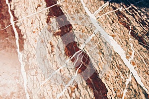 Texture of red and white marble stone close up. close-up layered rock structure