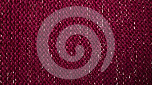 Texture of red wicker fabric background. fabric background with metal weave. Rough woven red material with shiny inserts. Texture