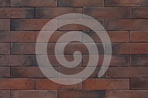 Texture of reddish-brown rectangular bricks wall, photo