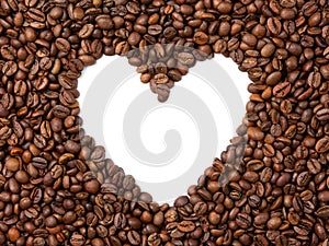 Texture of roasted coffee beans on white isolated background. In the center is the shape of the heart