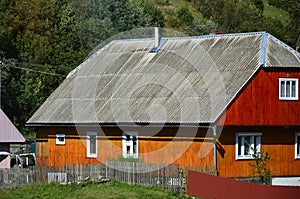 The texture of the roof with shiver slate coating. Rough and old roof of gray slate wavy sheets. Waterproof roofing from asbestos