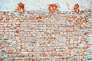 Texture of rough worn brick wall. Old facade as background. Urban patterns and details