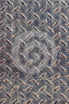 Texture of a rusty steel checkered plate with small rice projections