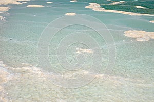 Texture of salt deposits in water. The Dead Sea dries up, the salvage of sea waters