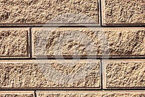 Texture of sand-colored bricks background close up