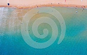 Texture of sea with clear turquoise water and bottom top view with the drone. iridescent yellow blue colors