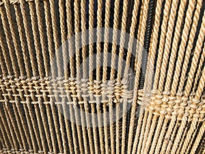 The texture of the set of brown interlaced natural ropes, ropes of thread. The background