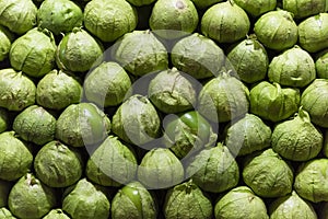 Texture of several raw green tomatoes in the market