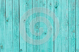 Texture of shabby wooden planks in blue. Peeling paint on wood grain surface. Old wooden background painted in turquoise colors.
