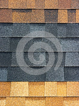 The texture of the shingles is close-up. Roofing material