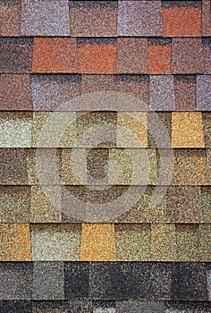 The texture of the shingles is close-up. Roofing material