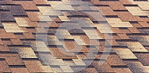 The texture of the shingles is close-up. Roofing material