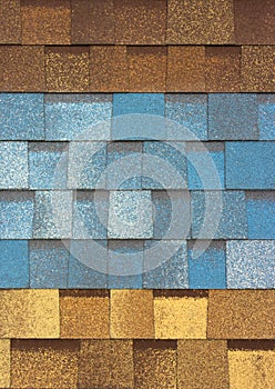 The texture of the shingles is close-up. Roofing material