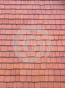 The texture of the shingles is close-up. Roofing material