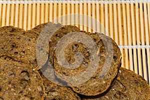 Texture of sliced wholemeal rye bread on bamboo background