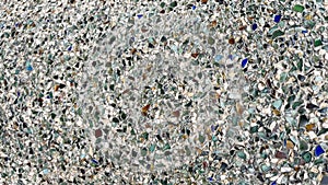 The texture of the small multi-colored stones and glass