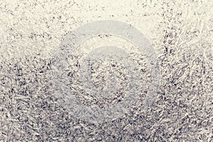 Texture of snow-white snowflakes on transparent glass. Beautiful frosty pattern on the window.