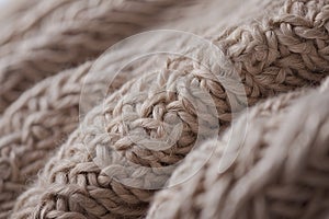 texture of soft knitted fabric made of thick beige coarse woolen threads