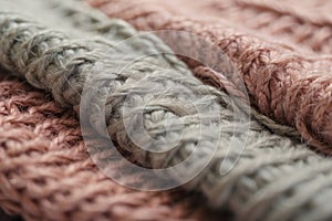 texture of soft knitted fabric from thick gray and pink coarse woolen threads