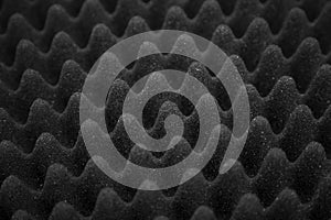 Texture soundproof panel of polyurethane foam. Abstract black rubber foam background