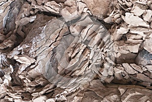 Texture of splinters cracked stones streaked and old crumbling concrete close-up gray color structure