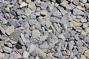 The texture of stone gravel gray. Stone rubble gray poured pile close-up. Stone path crushed