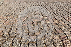 Texture of stone pavement tiles cobblestones bricks background.