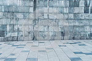 Texture of stone wall covered with tiles and pavement.