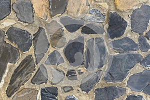 Texture of a stone wall. Gray stone wall background. Stone wall as a background or texture. Old castle stone wall texture.