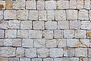 Texture of a stone wall from a large cobblestone shell closeup