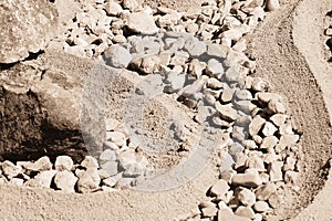 The texture of the stones and sand.