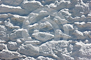 Texture of stonework covered by white stucco photo