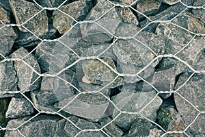 Texture of strengthened stone wall with metal wire