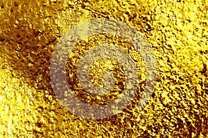 Texture of a surface of a golden nugget close-up for a background. Fused surface of gold. Bright and light yellow color. Template