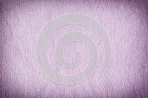 Texture of a terry towel lilac towel close-up. Blank light background with vignette.