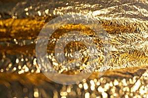 Texture of a thin crumpled sheet of foil. Crumpled foil background. Stock photo foil. Gold chrome color