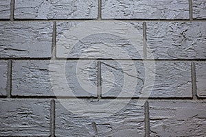 Texture of torn brick made of cement plaster by hand, front and background blurred with bokeh effect