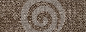 Texture of velvet dark brown background from upholstery textile material, macro. Abstract velour umber fabric photo