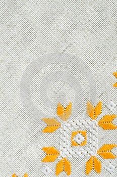 Texture of the vintage homespun linen textile. Background with embroidery.