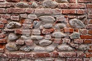 Texture of wall with regular red brick and with pieces of old red brick