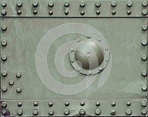 The texture of the wall of the tank, made of metal and reinforced with a multitude of bolts and rivets. Images of the covering of