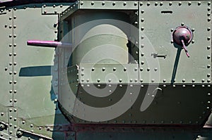 The texture of the wall of the tank, made of metal and reinforced with a multitude of bolts and rivets. Images of the covering of