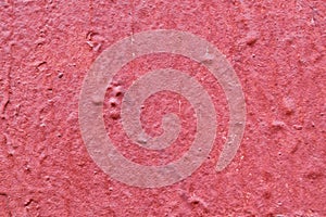 The texture of the walls of wood painted with red paint. Visible cracks, bumps and depressions.